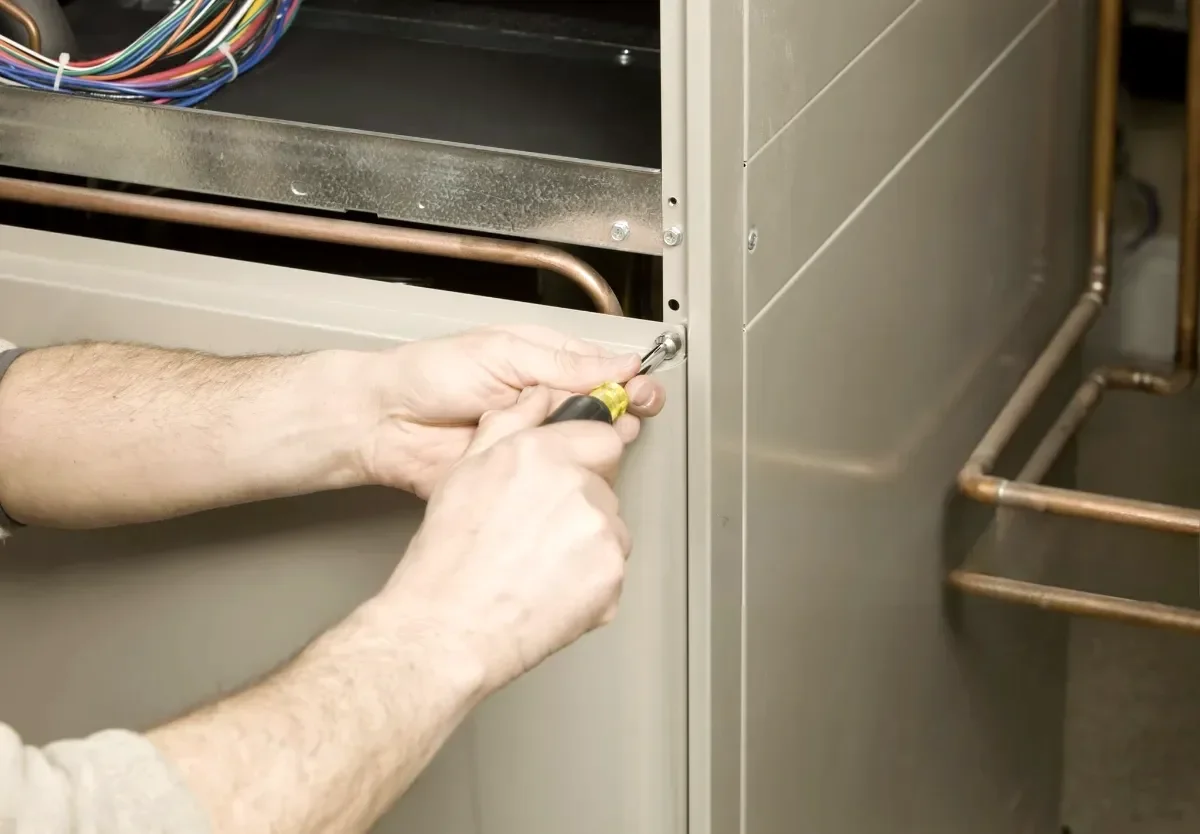 Technician servicing a residential furnace