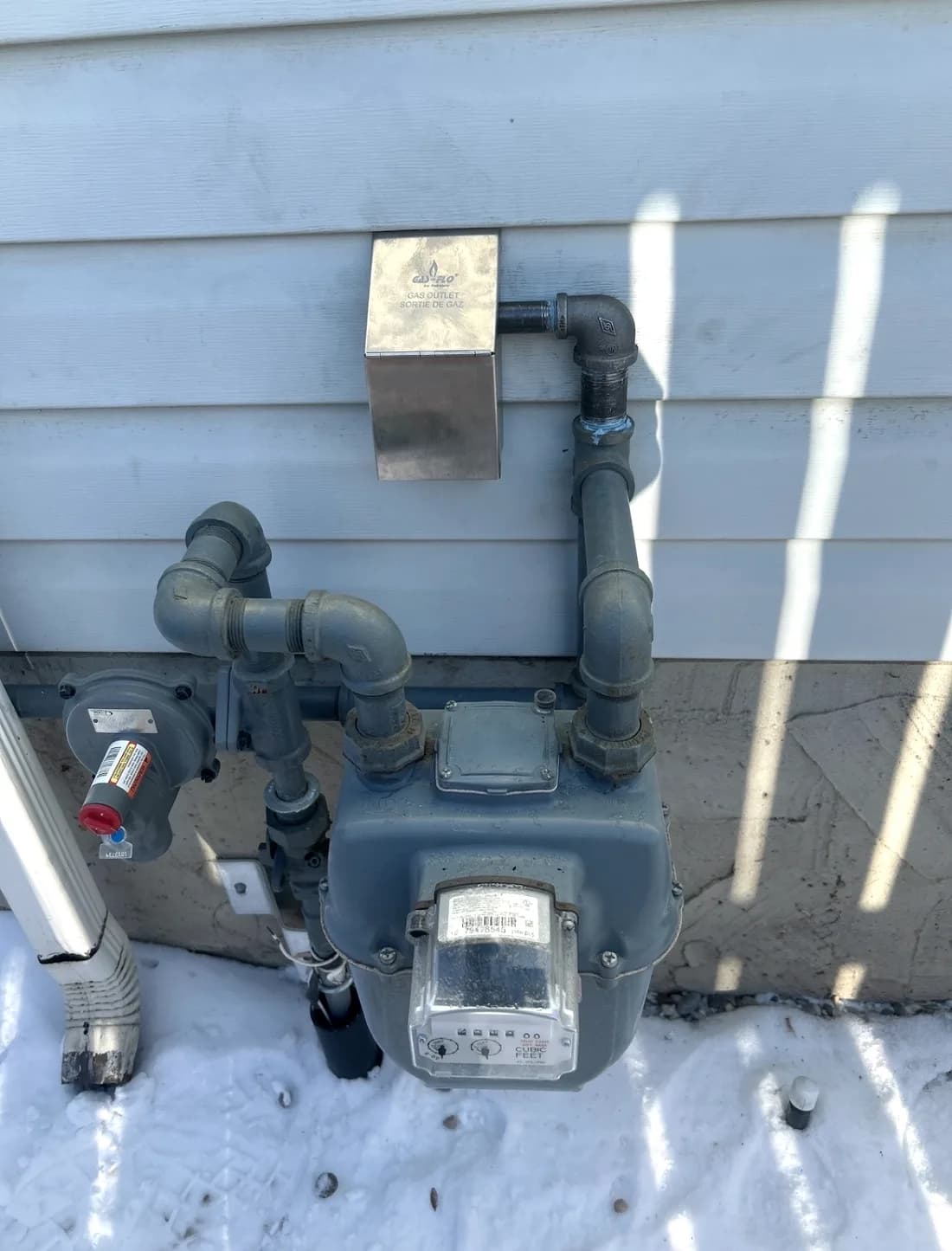 Natural gas meter and piping installed on a home