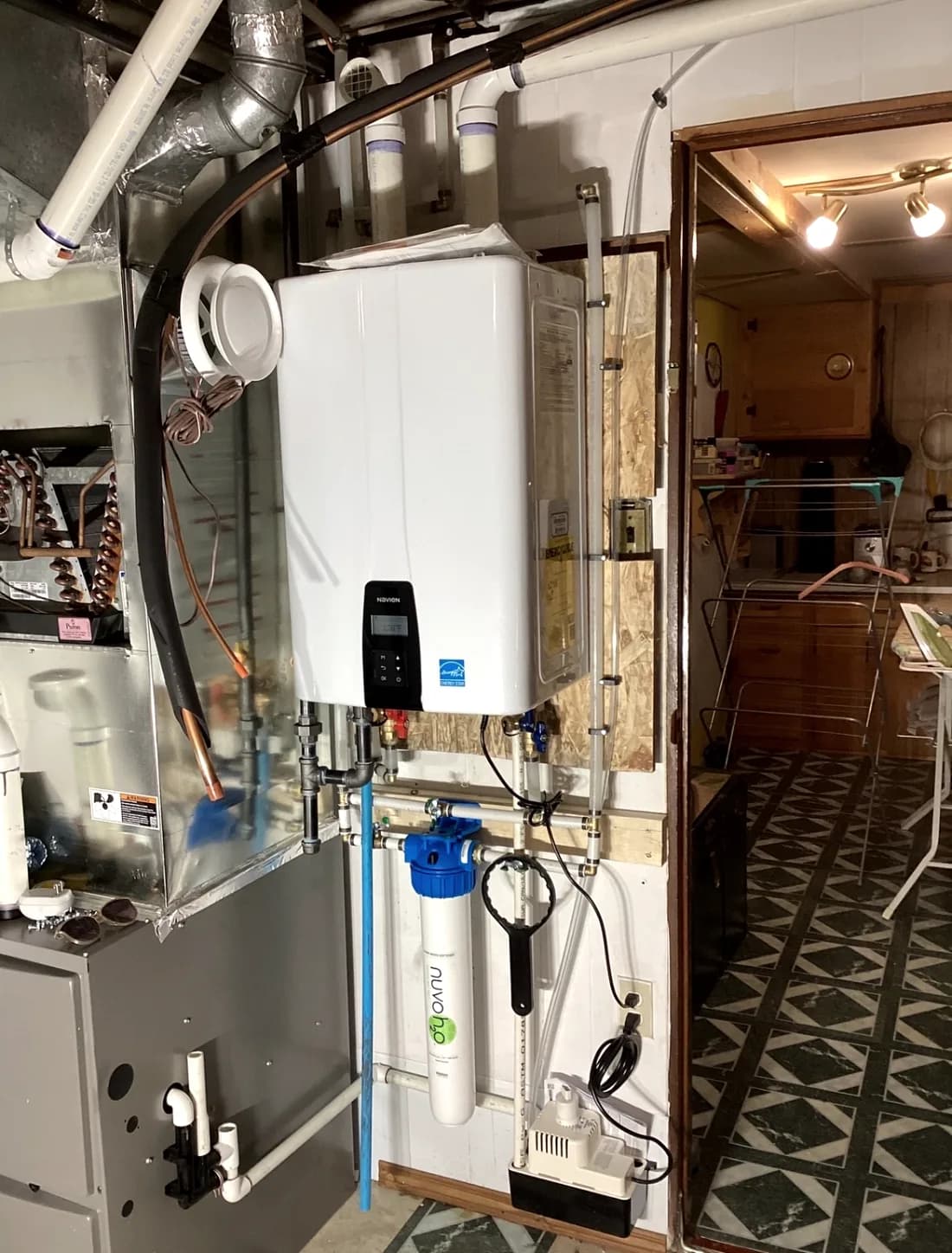 Tankless water heater installed in a utility room